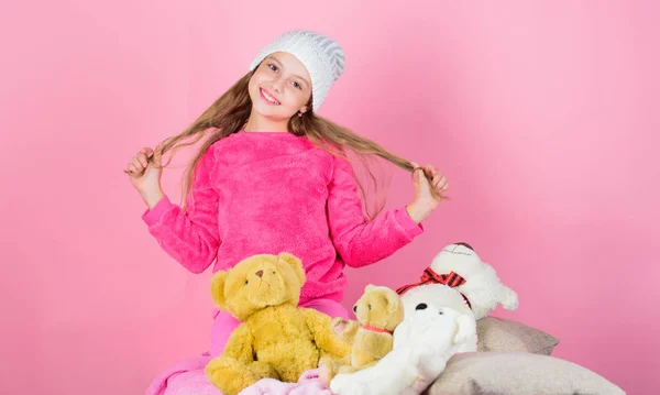 Child small girl playful hold teddy bear plush toy. Teddy bears improve psychological wellbeing. Unique attachments to stuffed animals. Kid little girl play with soft toy teddy bear pink background