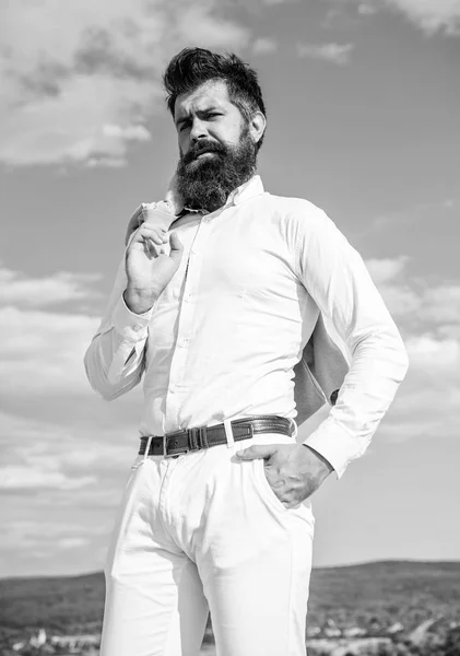 Real man style. Guy enjoy top achievement. Man bearded hipster formal clothes feels proud of himself sky background. Superiority and power. Hipster beard and mustache looks attractive white shirt
