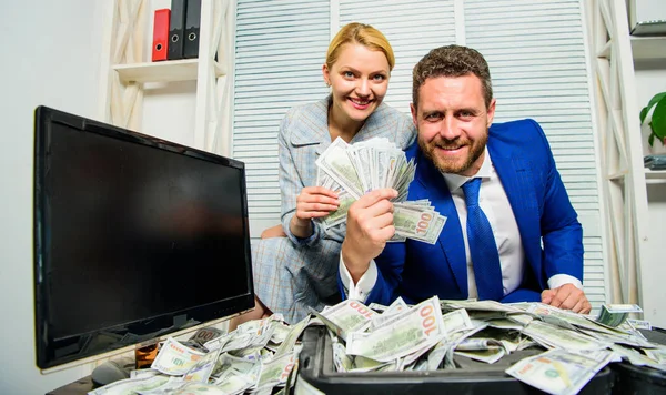 Huge profit concept. Counting money profit. Financial success. Man businessman and woman secretary with pile dollar banknotes. Profit and richness concept. Businessman near cash dollars profit