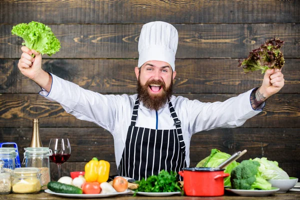 Healthy food recipe. Eat healthy. Dieting concept. Man wear hat and apron hold lettuce. Healthy nutrition. Bearded hipster professional chef hold lettuce greenery. Healthy vegetarian recipe