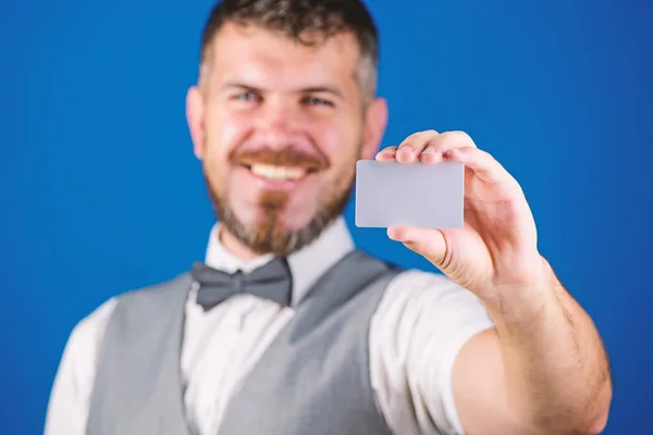 Man bearded hipster hold blank card blue background. Take this card. Make shopping easy. Which bank credit card easy get. Banking and credit concept. Plastic bank card copy space. Easy money credit