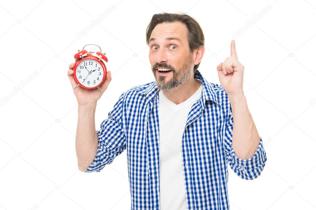 Check up time. Timekeeping and time measurement. Mature timekeeper with analog clock pointing finger up. Mature man holding alarm clock. Bearded senior man with mechanical clock in hand