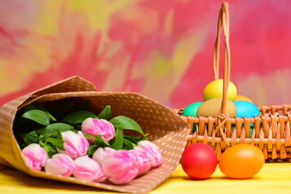 Spring holiday. Holiday celebration, preparation. Egg hunt. painted eggs in egg basket. Tulip flower bouquet. Healthy and happy holiday. Happy easter. Spring mood