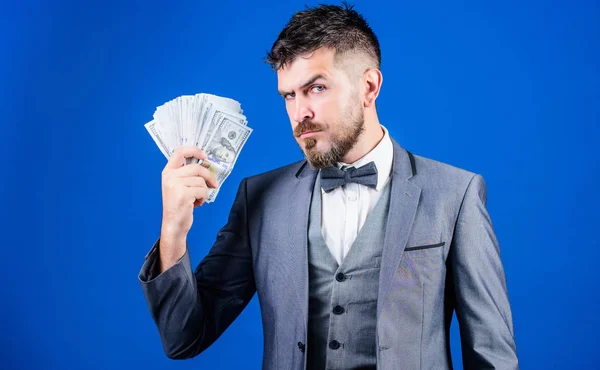 Investing money. Rich businessman with us dollars banknotes. Currency broker with bundle of money. Making money with his own business. Business startup loan. Bearded man holding cash money