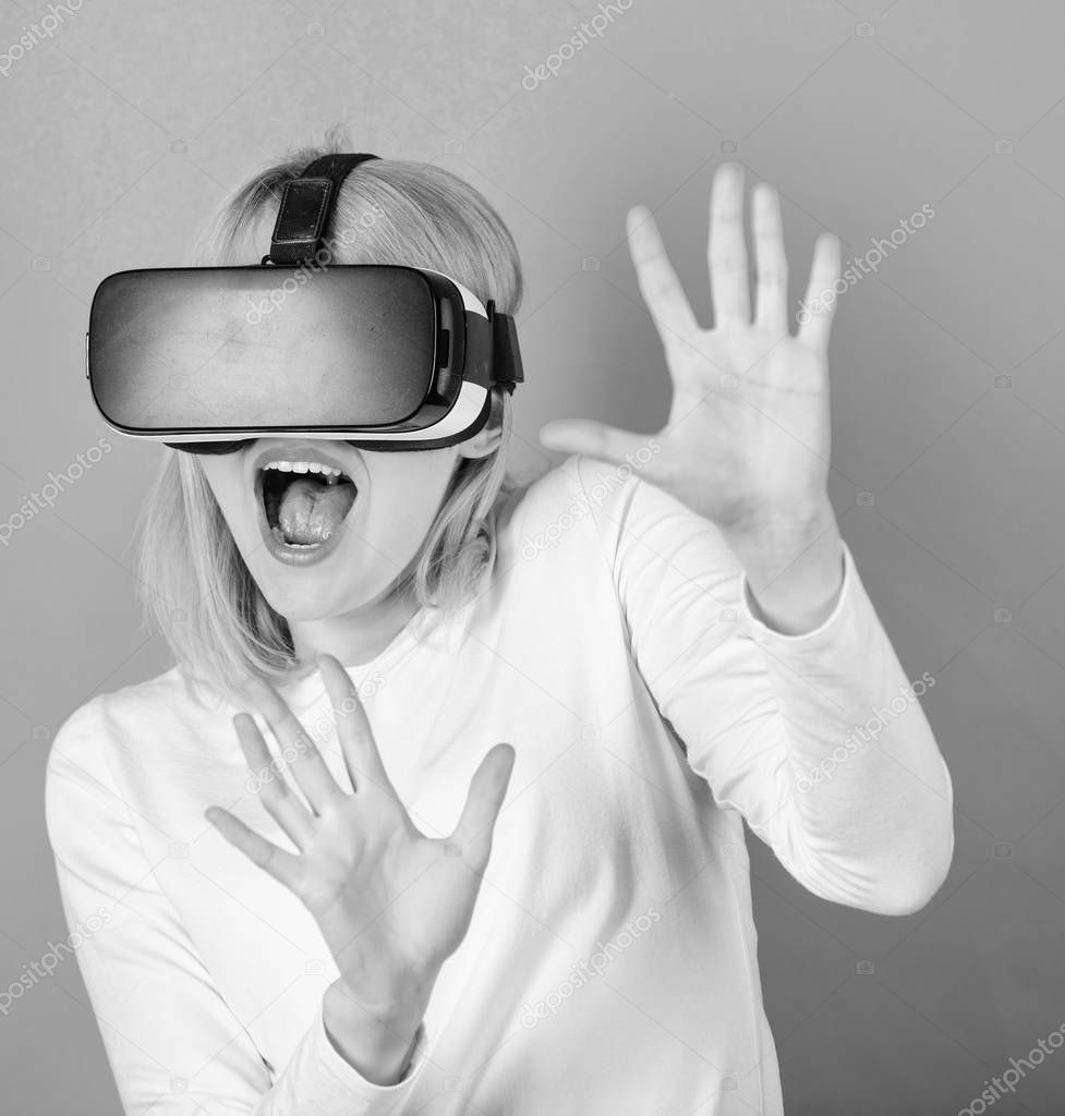 Funny young woman with VR. Woman using VR device. Virtual reality headsets.