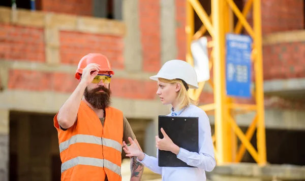 Inspecteur et bâtisseur barbu brutal discuter des progrès de la construction. Inspection du projet de construction. Inspection de construction, corrections et amendes. Discuter du projet en cours. Concept d'inspecteur de sécurité — Photo