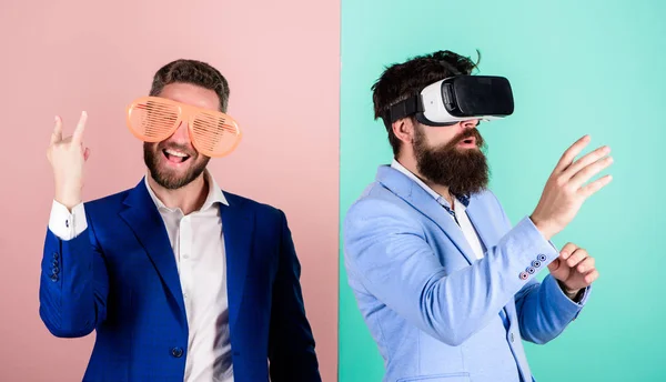 Man with beard in VR glasses and louvered plastic accessory. Guy interact in virtual reality. Hipster exploring virtual reality. Business implement modern technology. Real fun and virtual alternative