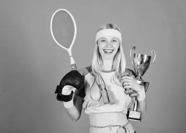 Champion concept. Girl sport instructor hold golden goblet of winner or champion. Woman good in tennis jumping boxing fitness sport. She is best in all competitions. Sport champion. Fitness champion — Stock Photo, Image