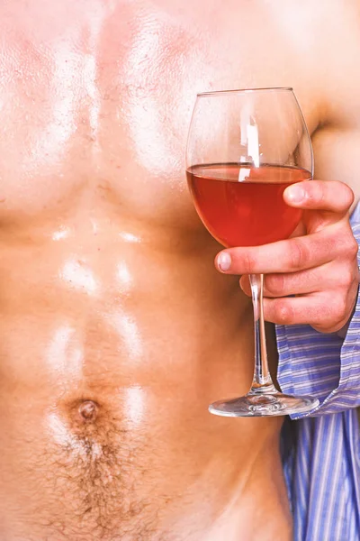 Male sexy chest wet skin after bath wineglass. Degustate luxury wine. Drink wine and relax. Enjoy wine after bath. Pleasant relax concept. Sweaty male relax with alcohol. Relaxing with alcohol drink