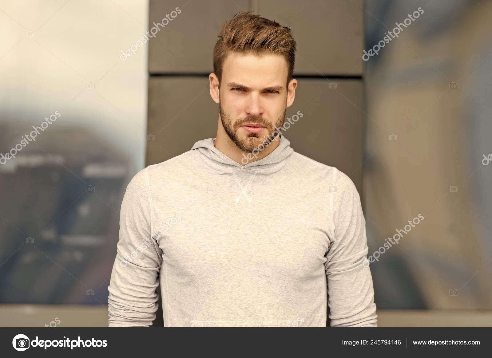 Metrosexual concept. Guy bearded and attractive cares about appearance. Man  with bristle on serious face, urban background, defocused. Man with beard  or unshaven guy looks handsome and cool Stock Photo by ©stetsik
