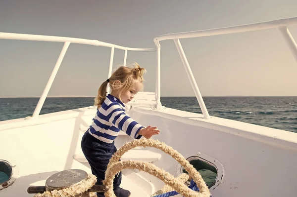 Yachting sport. Child cute sailor help with ropes yacht bow. Adventure boy sailor travelling sea. Baby boy enjoy vacation on cruise ship. Boy adorable sailor striped shirt yacht travel around world