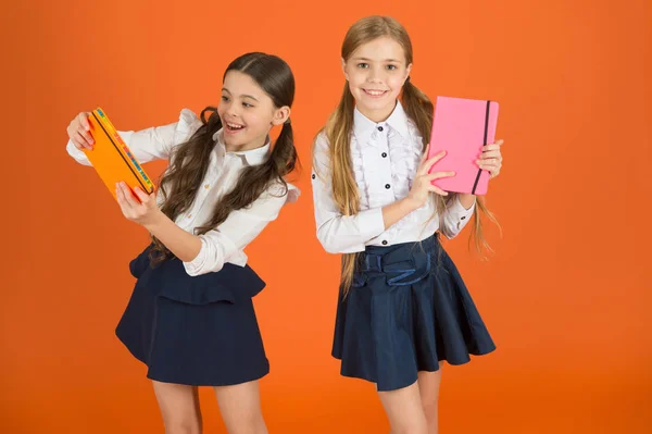 Dear diary. School stationery. Girls cute kids school uniform orange background. Schoolgirl show book diary or notepad. School supplies concept. We love study in school. Profile for friends notepad — Stock Photo, Image
