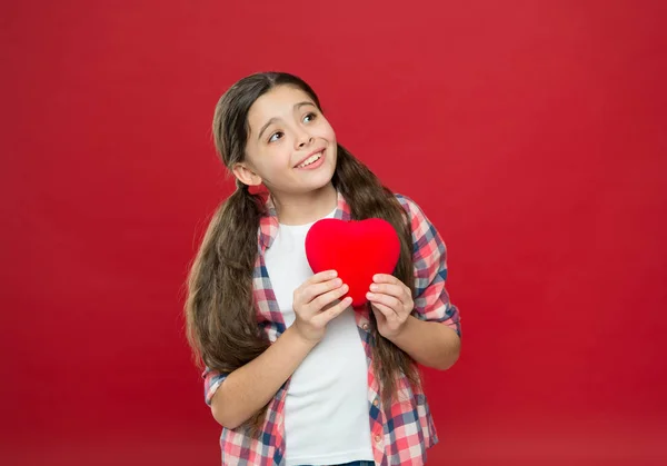 Celebrate valentines day. Love and romantic feelings concept. Red heart attribute of valentine. Heart gift or present. Greeting from sincere heart. Me to you. Girl cute child hold heart symbol love — Stock Photo, Image