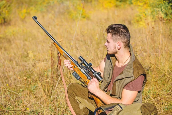 Man charging hunting rifle. Hunting equipment concept. Hunting hobby and leisure. Hunter with rifle looking for animal. Hunter khaki clothes ready to hunt nature background. Hunting shooting trophy — Stock Photo, Image