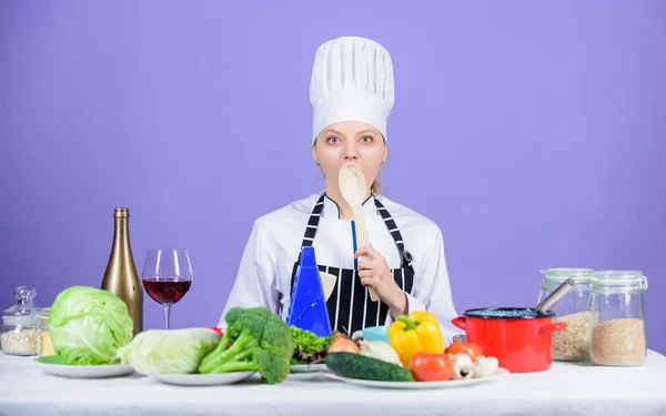 Cooking healthy food. Woman chef cooking healthy food. Fresh vegetables ingredients for cooking meal. Delicious recipe concept. Gourmet main dish recipes. Cooking is her hobby. Girl in hat and apron