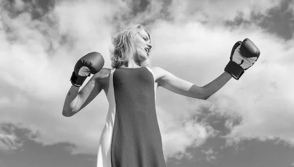 Lady fighter defend her point. Satisfied free girl boxing gloves. Femininity and strength balance. Woman red dress and boxing gloves enjoy victory. She fighter female rights. Assert her point of view