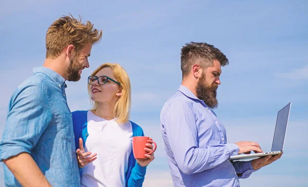 stock image Colleagues laptop work outdoor sunny day, sky background. Friends enjoy fresh air and keep working. Colleagues with laptop discussing plan. Outdoor workspace concept. Fresh air helps to refresh mind