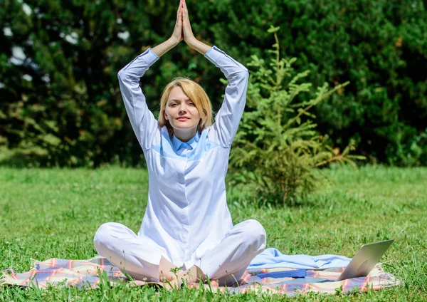 Woman relaxing practicing meditation. Every day meditation. Reasons you should meditate every day. Find minute to relax. Clear your mind. Girl meditate on rug green grass meadow nature background