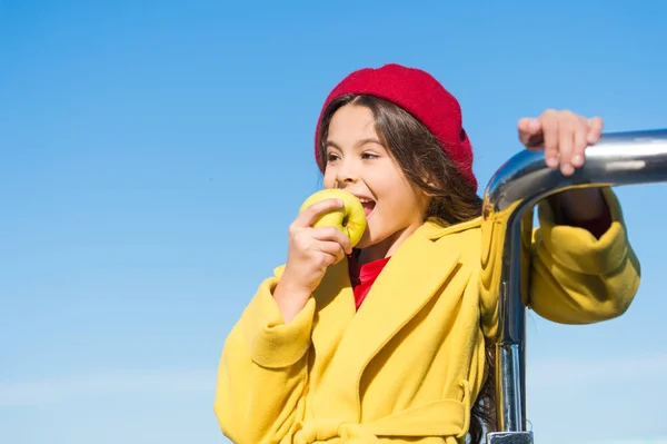 Kid girl eat apple fruit. Healthy diet. Snack while walk. Kids health and nutrition. Healthy snacking benefits. Snack between lunch and dinner. Having snack. Good nutrition essential good health