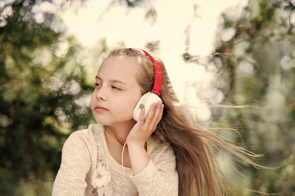 Cute little girl enjoying music using headphones — Stock Photo, Image