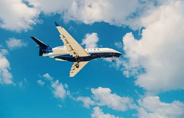 Philipsburg, Sint Maarten - February 13, 2016: aircraft fly on cloudy blue sky. Plane in clouds. Jet on flight on sunny day. Travel by air transport, aviation. Wanderlust, vacation and trip — Stock Photo, Image