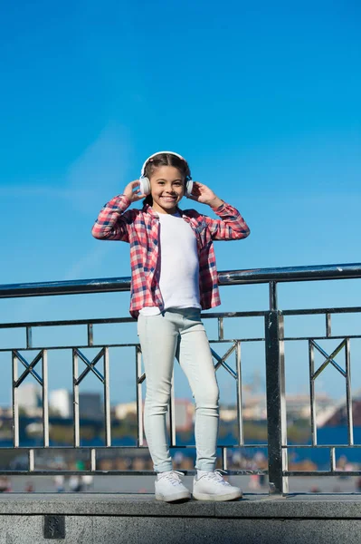 Discovering new music styles is great way into culture. Girl child listen music outdoors with modern headphones. Kid little girl listen song headphones. Music account playlist. Customize your music