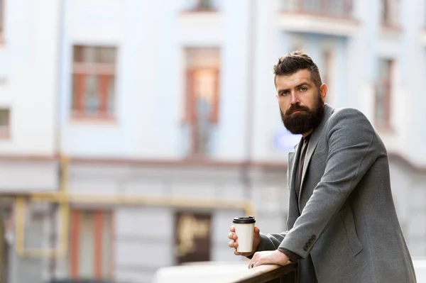 Relax and recharge. Man bearded hipster drinking coffee paper cup. One more sip of coffee. Enjoying coffee on the go. Businessman well groomed appearance enjoy coffee break out of business center