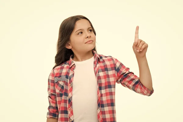 Wait a minute. Girl pointing upwards index finger. Child warning or asks for attention. Girl casual outfit thoughtful face pointing direction. Kid with index finger pointing upwards direction