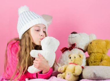 Küçük kız oyun yumuşak oyuncak oyuncak ayı ile pembe arka plan evlat. Çocukların duyguları işlemek ve stres sınırlamak yardımcı. Oyuncak koleksiyonu taşıyor. Çocuk küçük kız oynak oyuncak ayı peluş oyuncak tutun