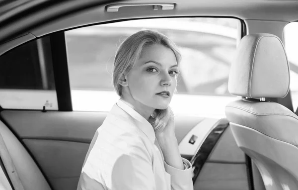 Business lady passenger luxury car salon. Personal assistant and driver. Business life concept. Business woman sit on backseat. Busy lady passenger leather car salon enjoy journey with chauffeur