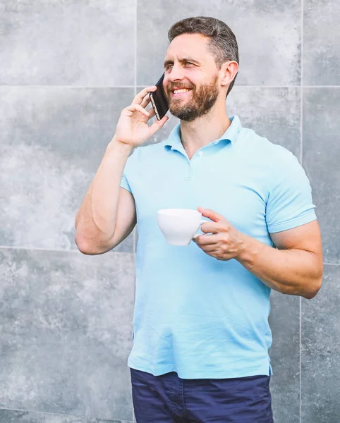 Man drink cappuccino speak phone grey wall background. Even if you drink coffee on the go each sip is little break in your day and little moment of self care. Reasons entrepreneurs drink coffee