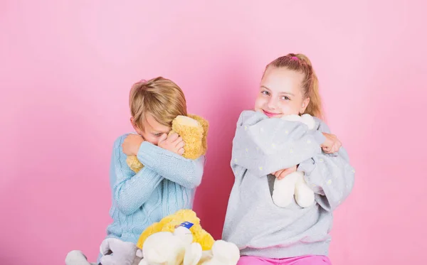 Bears toys collection. Teddy bears help children handle emotions and limit stress. Siblings playful hold teddy bear plush toys. Boy and girl play with soft toys teddy bear on pink background — Stock Photo, Image