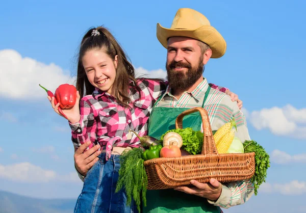Man bearded rustic farmer with kid. Father and daughter hold basket harvest vegetables. Gardening and harvesting. Family farm concept. Farmer family homegrown harvest. Only organic and fresh harvest — Stock Photo, Image
