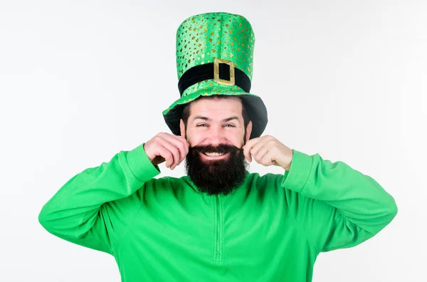 Keeping his moustache in shape. Hipster in leprechaun hat and costume. Bearded man celebrating saint patricks day. Happy saint patricks day. Irish man with beard wearing green Stock Picture