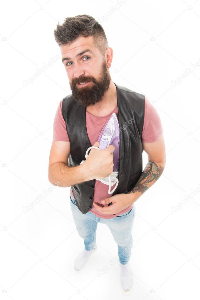 Warming his heart. Man bearded hipster hold electric ironing tool. How iron clothes correctly. Be careful. Guy with iron on white background isolated. Tailor and dry cleaning service. Household duty