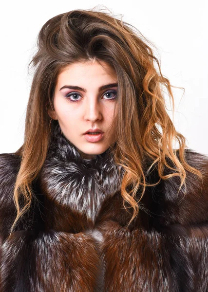 Winter hair care tips you should follow. Hair care concept. Girl fur coat posing with hairstyle on white background close up. Prevent winter hair damage. Woman makeup calm face hair volume hairstyle.