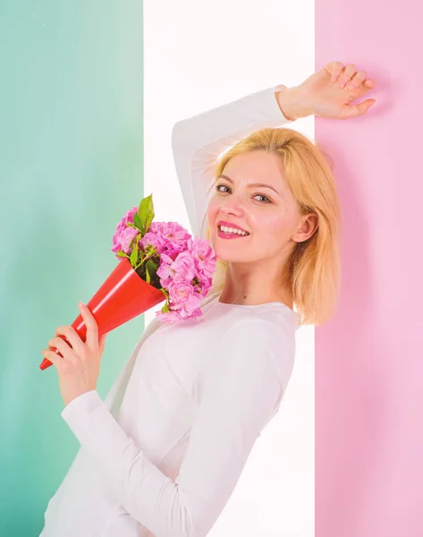 Lady happy received flowers from secret admirer. Woman smiling dreamy try guess who fall in love with her. Girl hold bouquet flowers enjoy fragrance and feels admired. Who is her secret admire