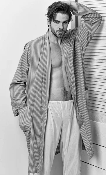 Macho in bathrobe with strong chest and six packs. — Stock Photo, Image