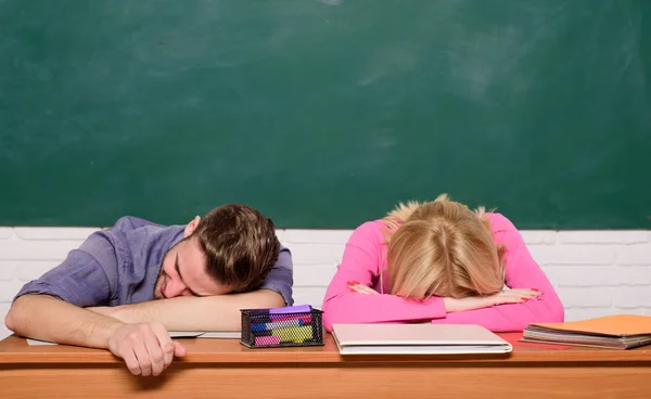 Feeling bored. Studying in college or university. Apply for free program. Couple friends student studying university. Student life issues. Guy and girl tired or lazy student lean on desk in classroom — Stock Photo, Image