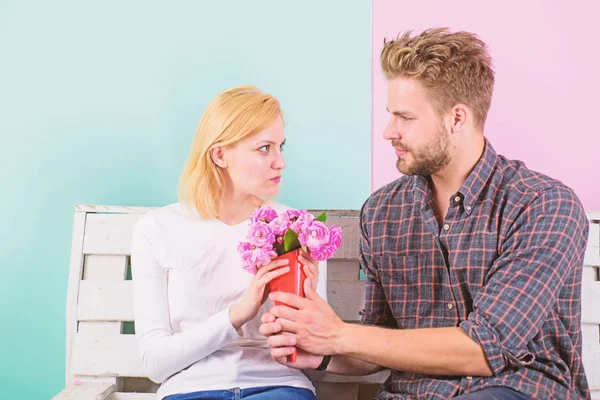 She hate flowers because of allergy. Man choose wrong flowers. Girl unhappy hold bouquet flowers she hates. Woman angry face not appreciate gift. Romantic date failures. How guess flowers she likes