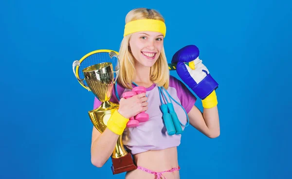 Champion concept. Girl successful modern woman hold golden goblet of champion. Woman good in tennis jumping boxing fitness sport. How to find time for everything. Sport champion. Fitness champion