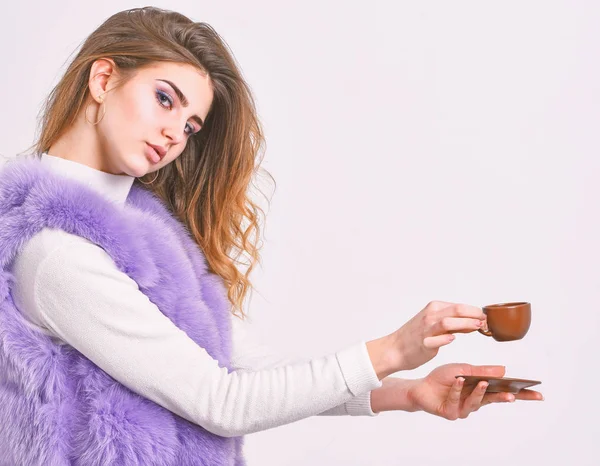 Enjoy aroma and taste hot coffee. Woman fur coat drink coffee. Elite coffee concept. Elite coffee variety concept. Elite drink with caffeine. Lady drink espresso little ceramic cup white background