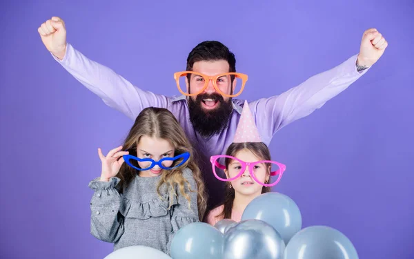 Pleasure cannot wait. Happy family with two children. Family of father and daughters wearing fancy glasses. Father and girl children enjoying party. Happy family celebrating. Family day celebration