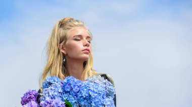 Yumuşak model kız, ortanca çiçeği buketi tutuyor. Makyaj ve moda tarzı. Moda modası ilkbaharı. Baharı yeni parfümle karşıla. Çiçekler güzel kokuyor. Moda ve güzellik endüstrisi