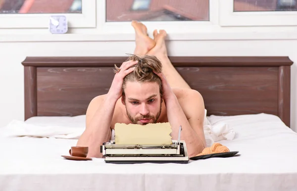 Erotic literature. Daily routine of writer. Man writer lay bed with breakfast working. Writer handsome author used old fashioned manual typewriter. Morning bring fresh idea. Morning inspiration