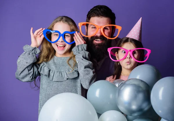 Happy fathers day. Happy family celebrating birthday party. Having a family celebration. Family party. Family of father and daughters wearing party goggles. Father and girl children enjoying party