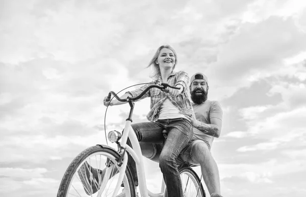 Psychology of relationships. Leadership in family and marriage. Girl controls bicycle handlebar. Couple in love date cycling. Let her be leader. Couple with bicycle romantic date sky background