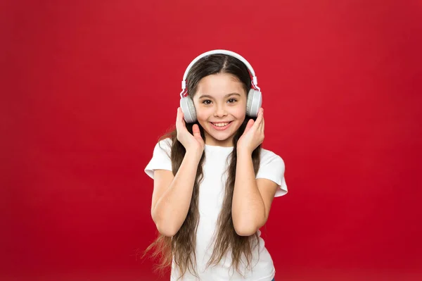 Music taste. Music plays an important part lives teenagers. Powerful effect music teenagers their emotions, perception of world. Girl listen music headphones on red background. Play list concept — Stock Photo, Image