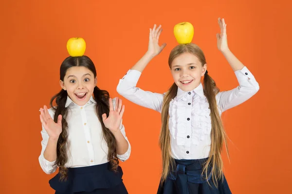 Laat voedsel worden van de geneeskunde. Kleine meisjes school snack nemen. Kleine meisjes eten van natuurlijke vitamine. Schattig schoolmeisjes holding appels. De kinderen van de school met gezonde snack. Vruchten zijn rijk aan vitamine — Stockfoto