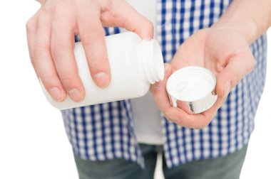 Küçük bir hap insanların hayatını kurtarabilir. Hap şişesi. adam el ile tıp hap ya da vitamin şişe açılış. Vitamin hapı kapsayıcı. Vitamini karmaşık. Vitamin takviyesi. Sağlık daha iyi sağlık için
